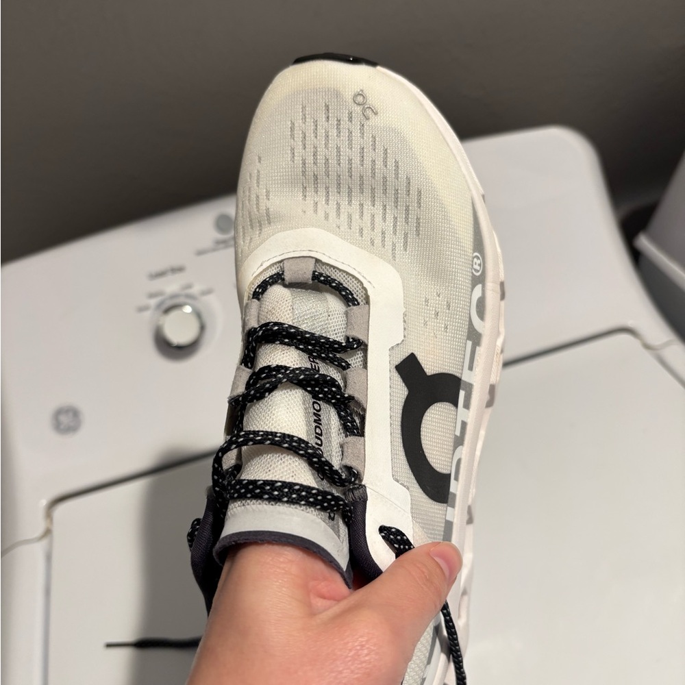 On Running Cream and Black Athletic Shoes